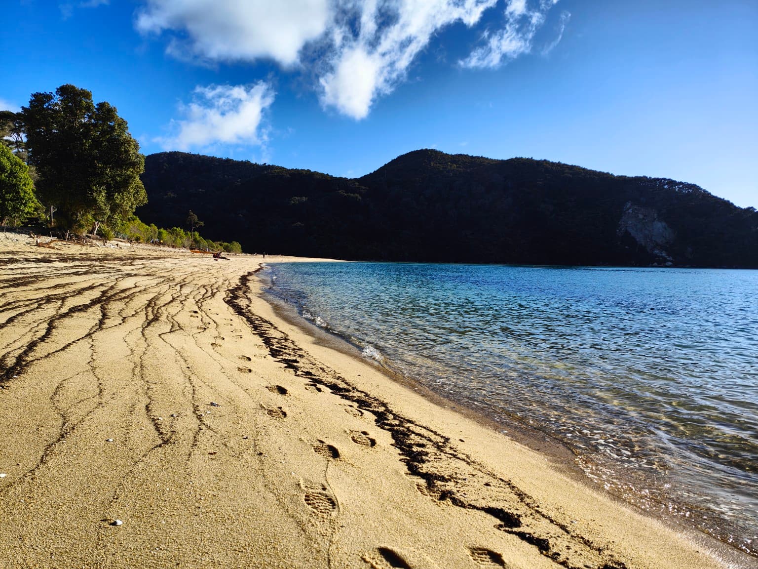 The tide left fine lines across a beach of golden sand.