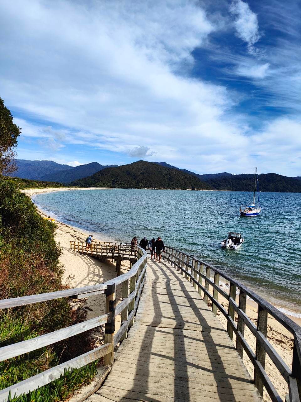 The timber walkway and water taxis at Awaroa Beach