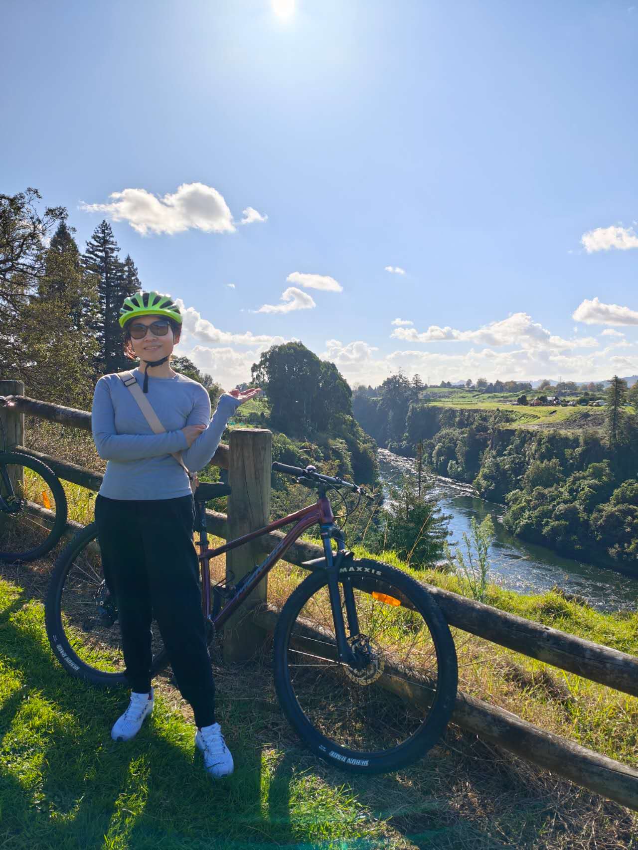 Katherine in a green helmet above the Waikato River valley