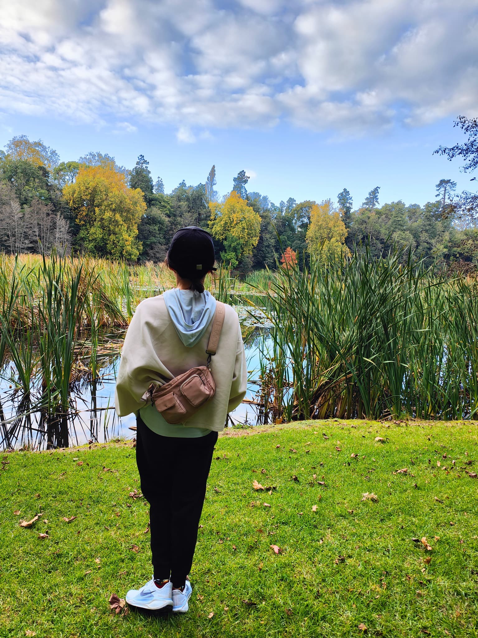 Katherine standing beside Lake Te Koo Utu in autumn