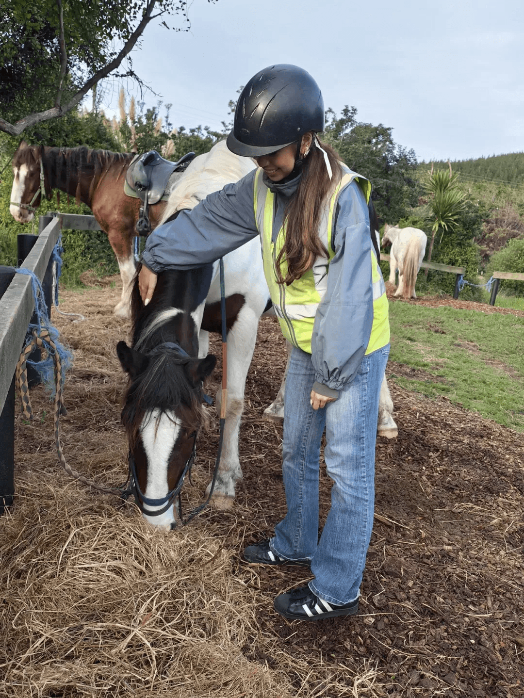 Ella gently touching her horse before the ride