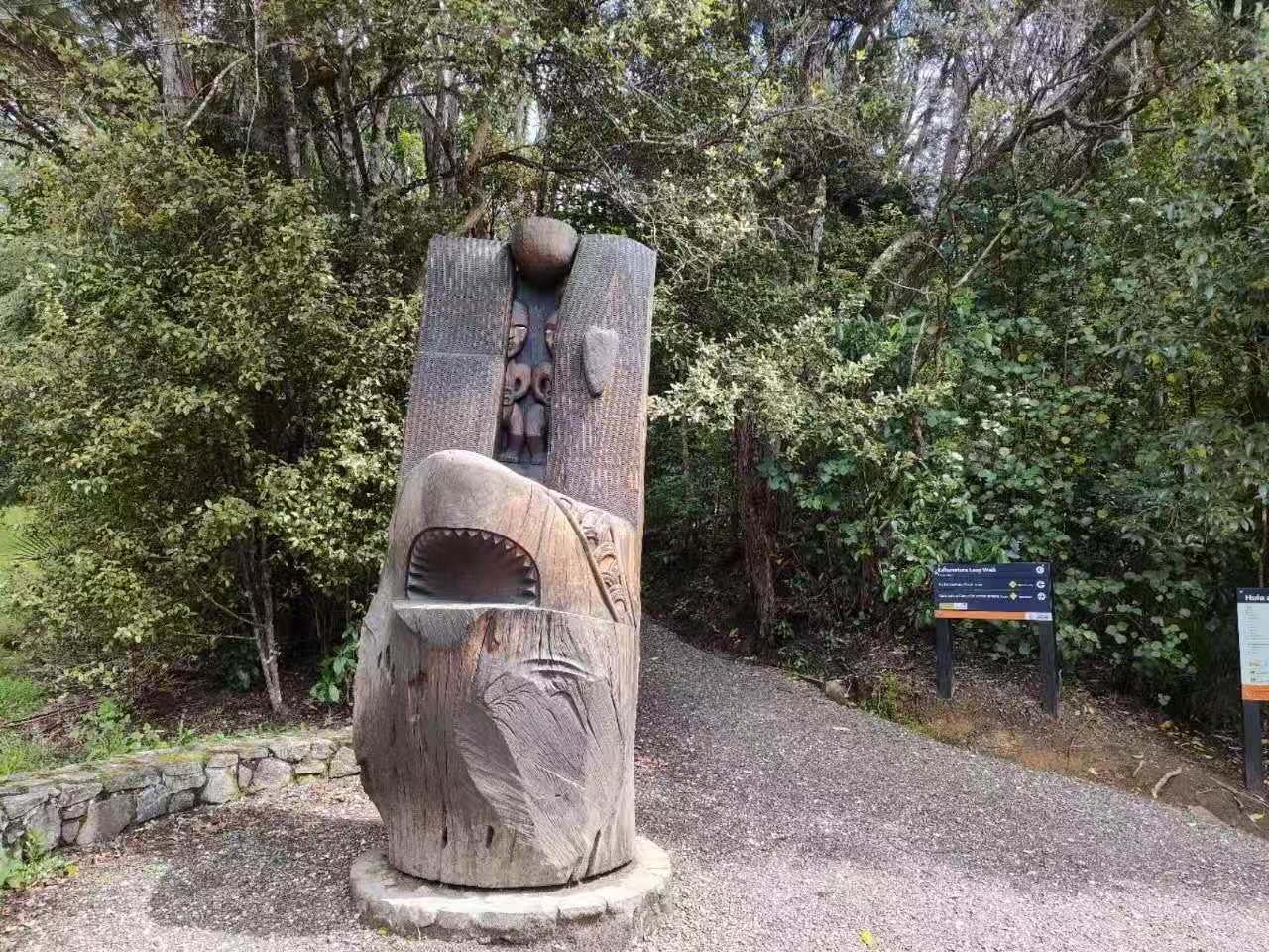 Māori carving and the forest track at the Karamatura trailhead