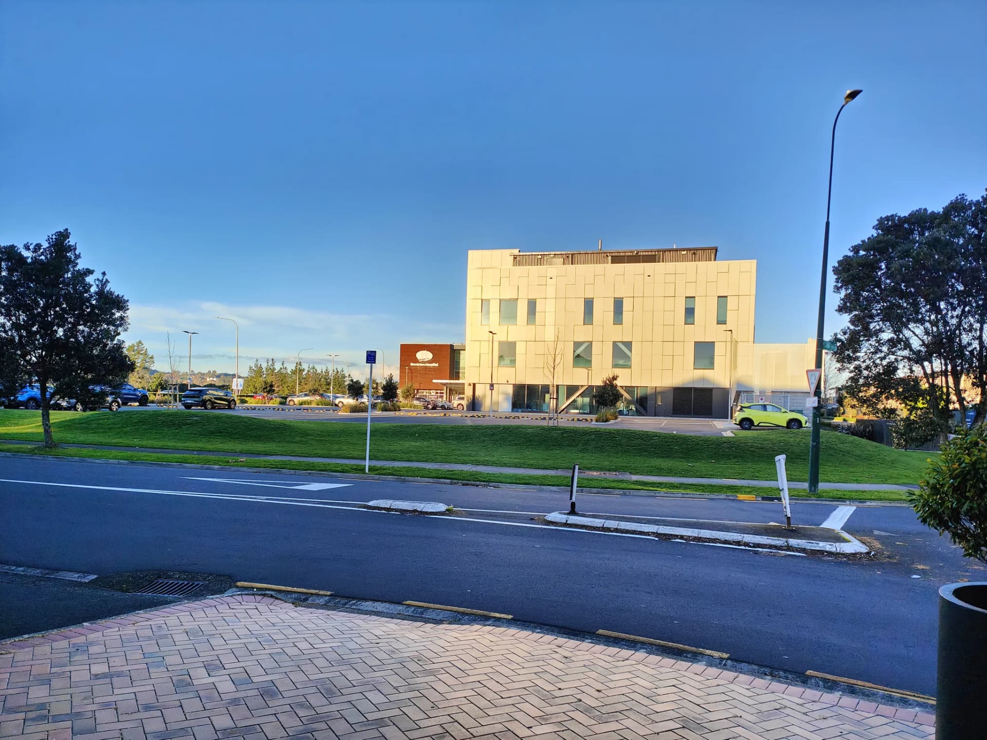 Lawn beside the shop with a private hospital in Ormiston in the distance
