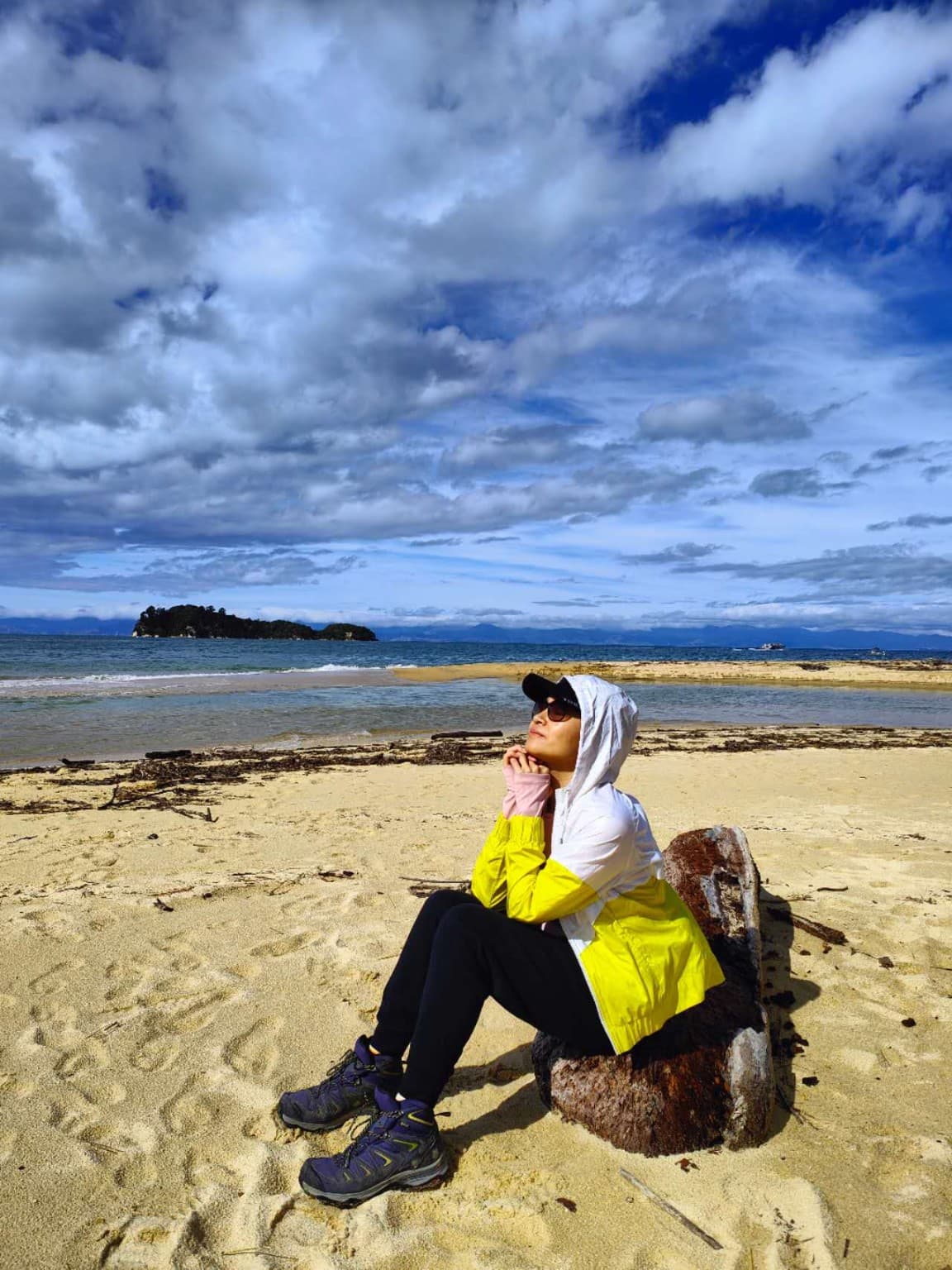 Katherine beside driftwood at Apple Tree Bay