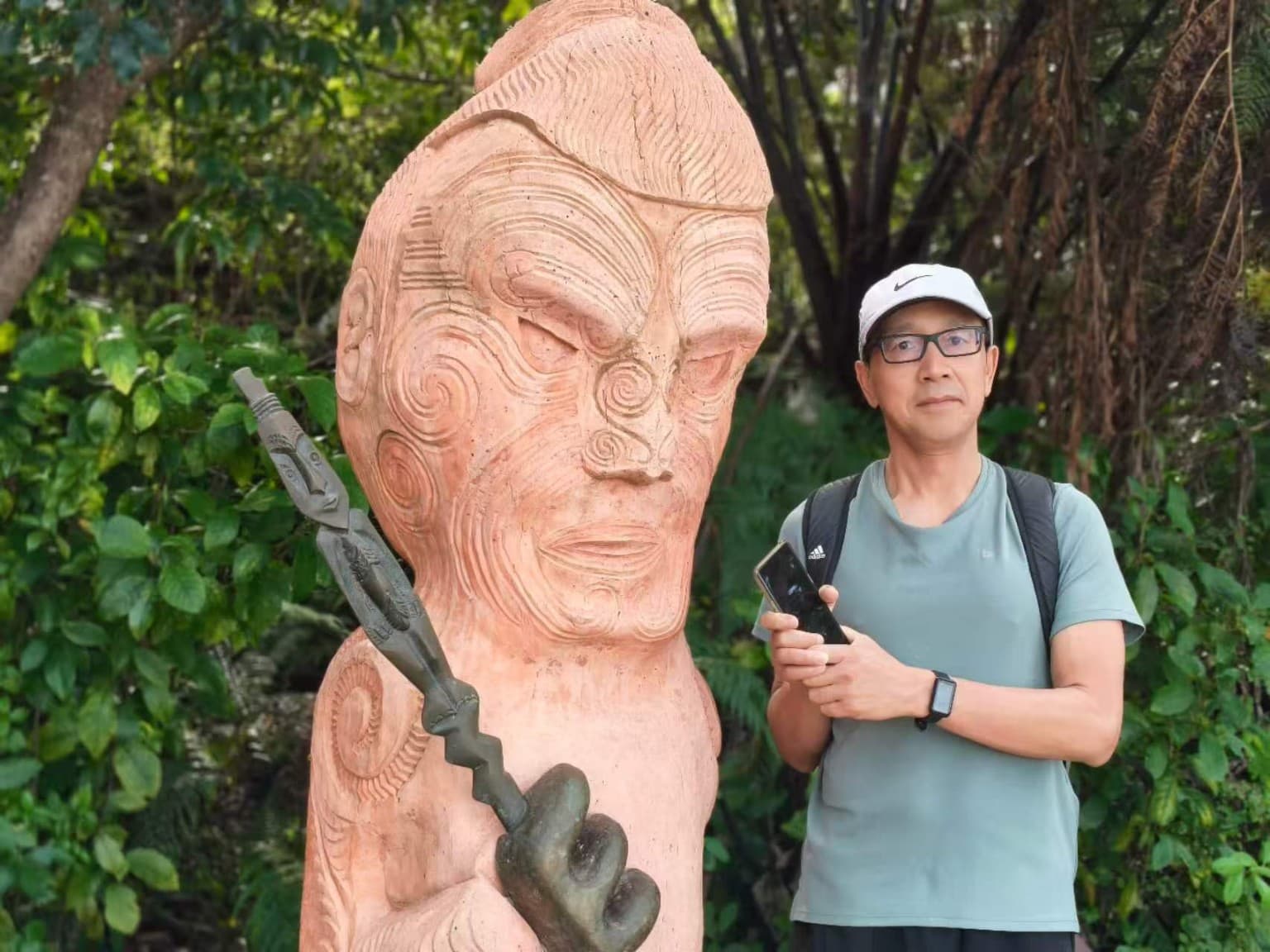 The author beside the entrance carving at Mārahau